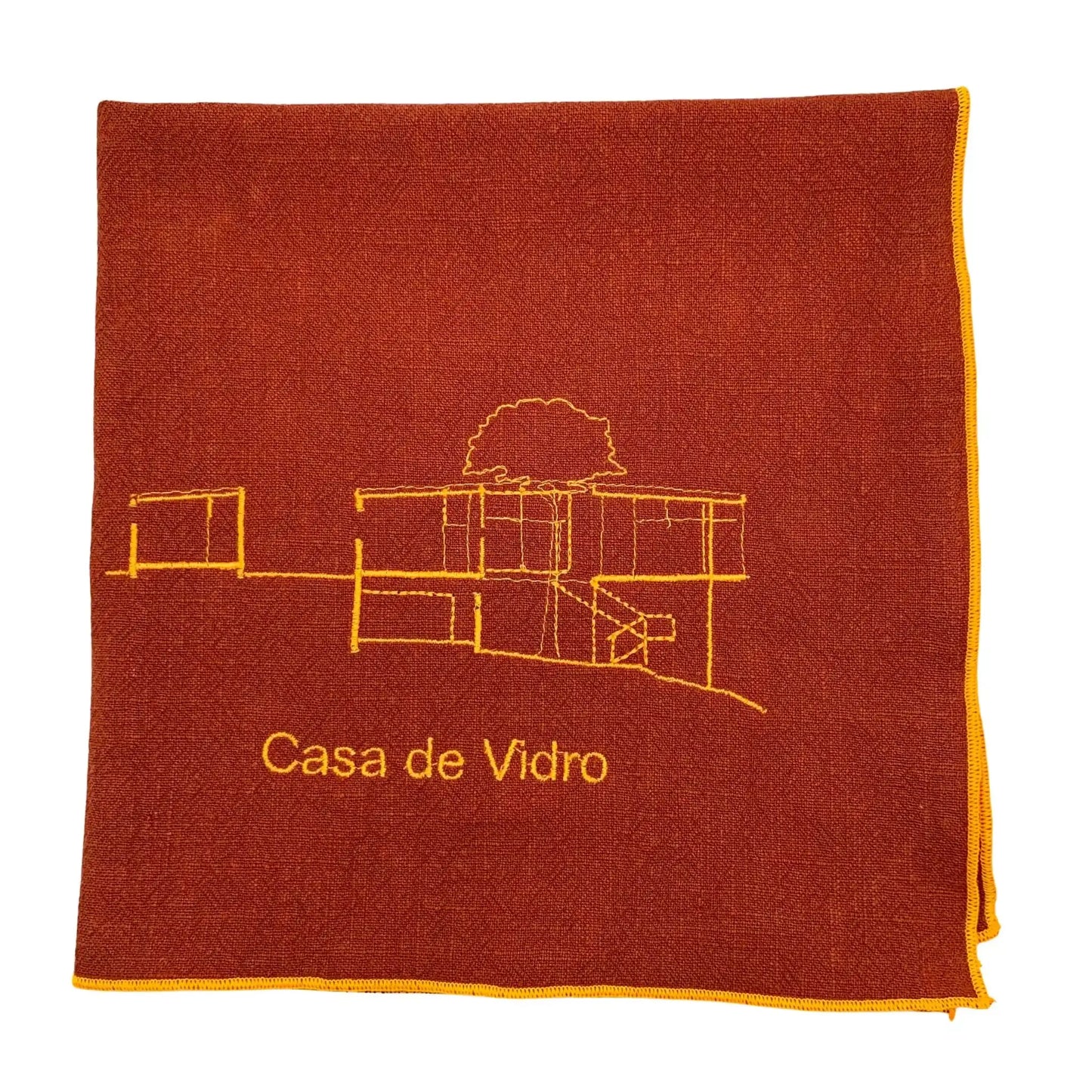 Serviette en lin lavé couleur piment avec des finitions néon orange brodée du plan du célèbre projet d'architecture Casa de Vidro conçu par l'architecte Lina Bo Bardi_vue produit