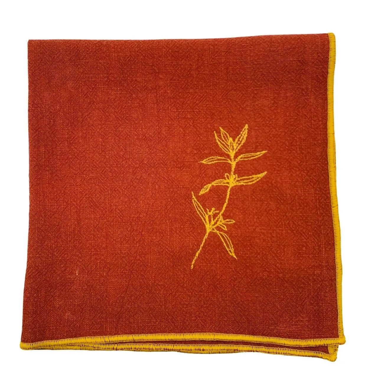 Serviette en lin lavé couleur piment, finition dorée_brodée d'une plante aromatique