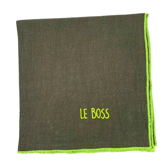 Serviette en lin lavé couleur vert safari, finition jaune néon, avec un nom brodé. vue produit